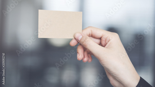 Woman holding the business card