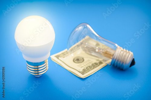 Led light bulb lay next to incandescent bulb 