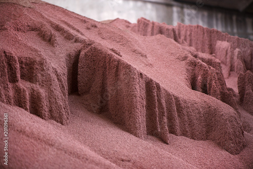 Shot of mixed chemical, artificial nitrogen plant fertilizer granules in factory. Big heaps of mineral pellets creating abstract textures, patterns. Minerals used in agriculture, farms, fields