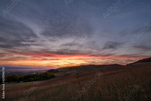 Romantic  bright and colorful sunset over a mountain range in Transilvania. Beautiful  colorful autumn background