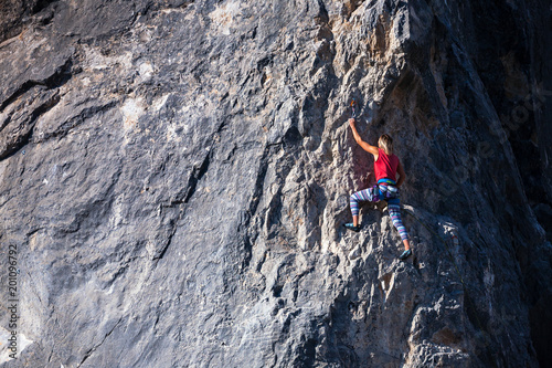 A woman climber on a rock.