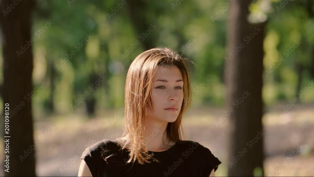 beautiful young woman with long hair looks. in the camera lens. beautiful young woman with long hair looks. in the camera lens.