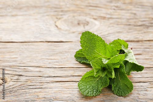 Fresh mint leafs on grey wooden table