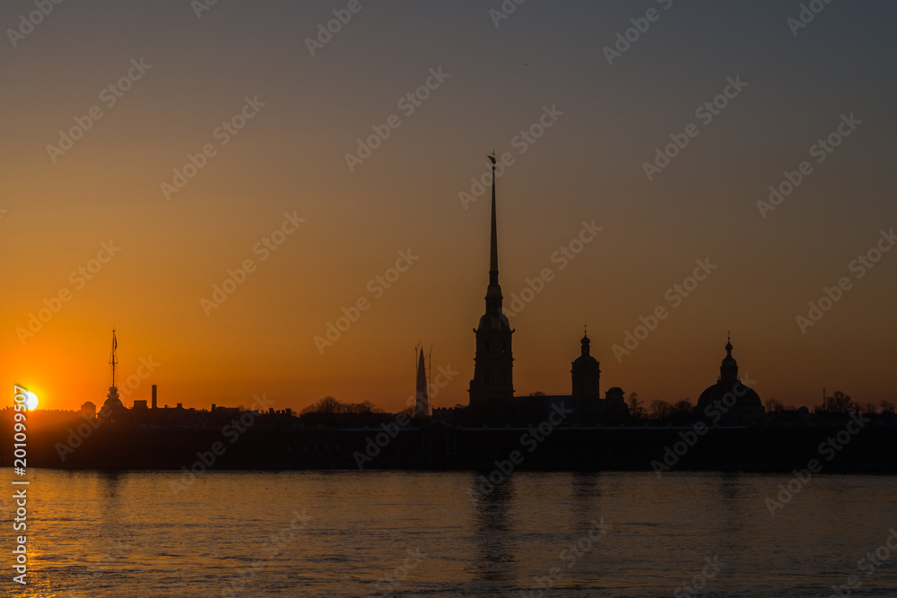 Golden sunset on the Neva embankment overlooking the Peter and Paul fortress.