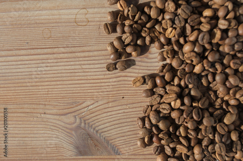 Coffe beans on the wooden background © AlemTMA