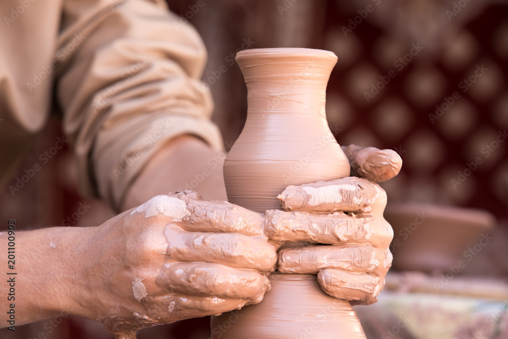 Closeup portrait of a sculptor master doing pottery.