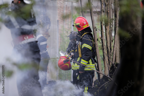Firefighters using water hoses to extinguish a fire