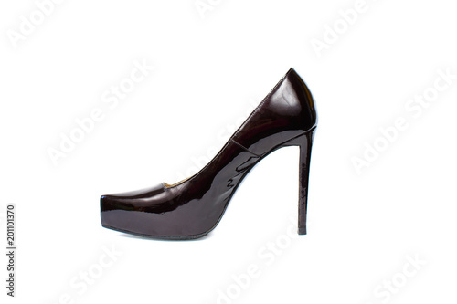 Lacquered black sexy shoe with high heel isolated on white. Women classic varnished shoe close up. One fashionable elegant luxury footwear item.