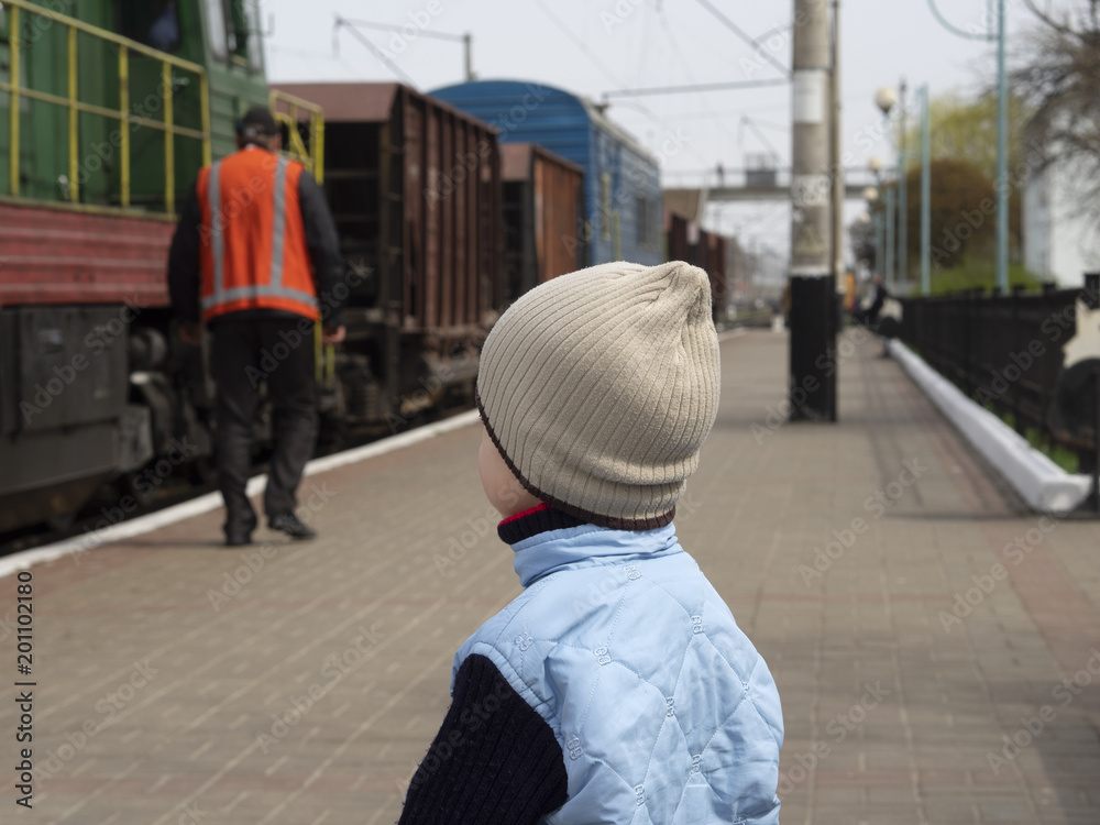 boy looks at a railwayman boy looks at a railwayman