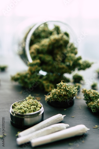 weed Joint Macro of cannabis buds marijuana with trichomes and crushed weed on a black table insta close up
