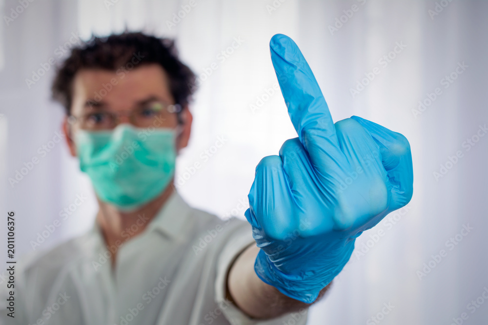 weird looking doctor shows gesture of middle finger up weird looking doctor shows gesture of middle finger up
