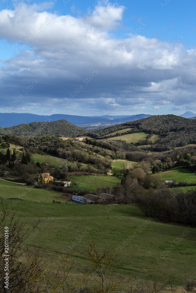 Spring scenery with hills and mountains on the background