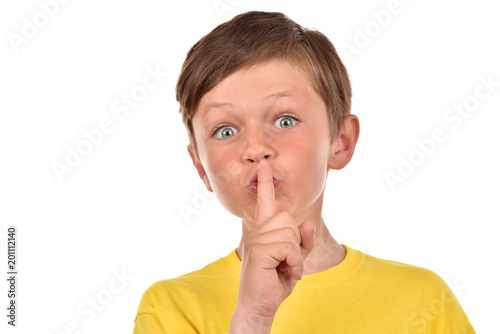Portrait of a boy on a white background. Emotional child. Studio pictures of a teenager.