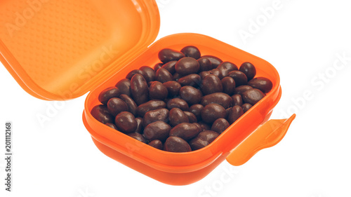 Fototapeta Naklejka Na Ścianę i Meble -  candy, chocolate-covered raisins in the orange box on white background