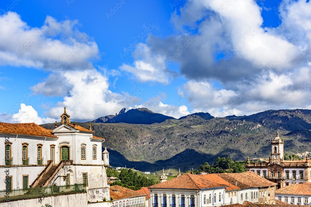 Top view of the center of the historic Ouro Preto city in Minas Gerais, Brazil with its famous churches and old buildings with hills in background