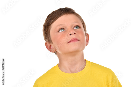 Portrait of a boy on a white background. Emotional child. Studio pictures of a teenager.