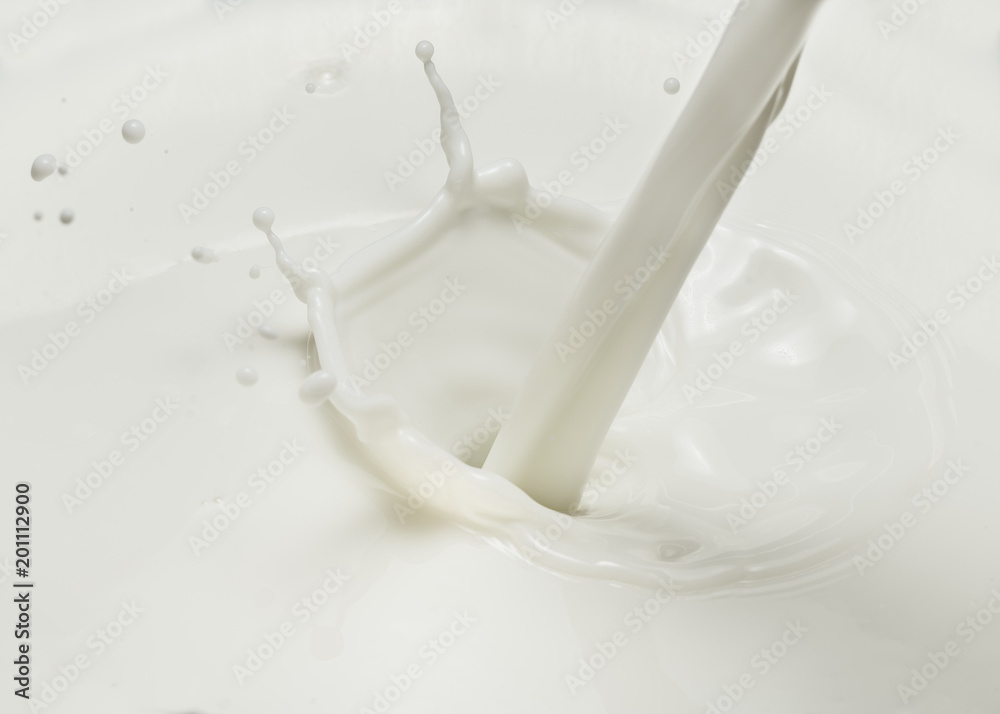 Pouring milk and milk splash. Close-up. Pouring milk and milk splash. Close-up.