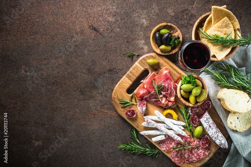 Antipasto - sliced meat, ham, salami, olives and glass wine