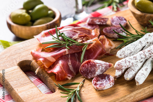 Antipasto delicatessen - sliced meat, ham, salami, olives on woo