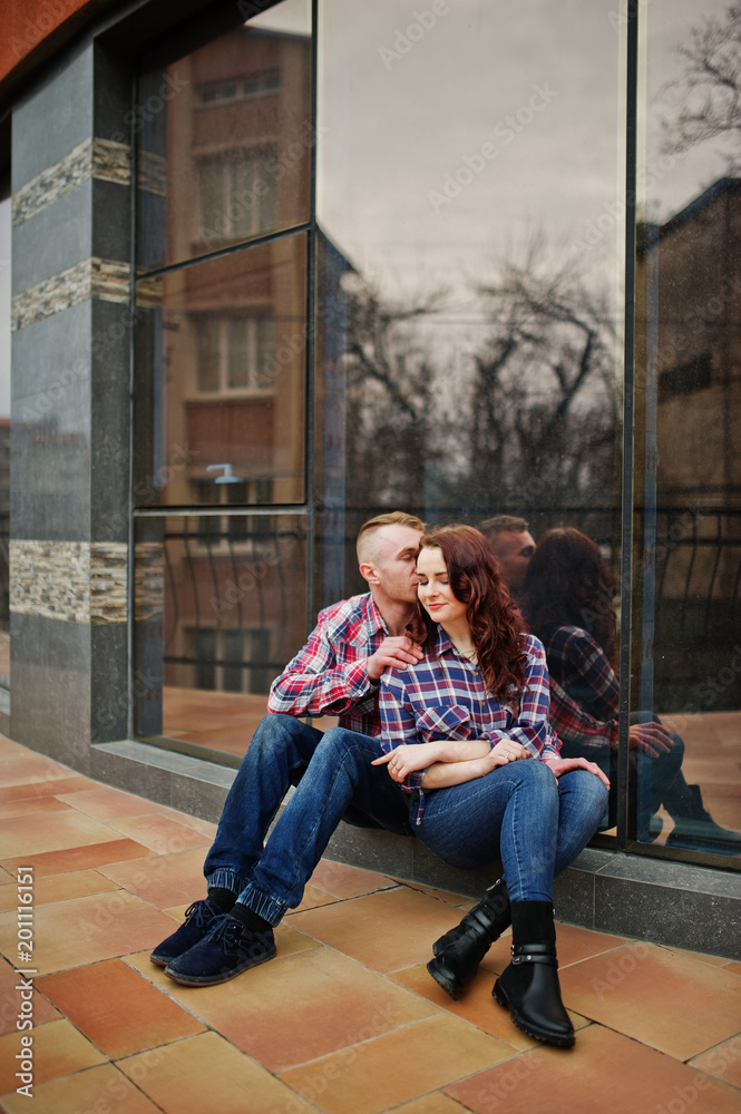 Stylish couple wear on checkered shirt in love together.