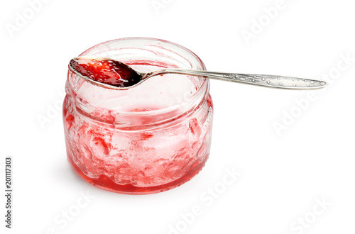 Leftovers of tasty sweet jam in glass jar on white background photo