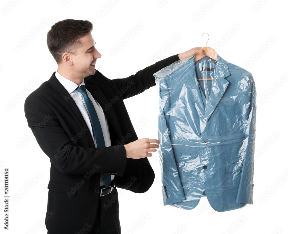 Young businessman holding hanger with jacket in plastic bag on white  background. Dry-cleaning service Stock Photo | Adobe Stock