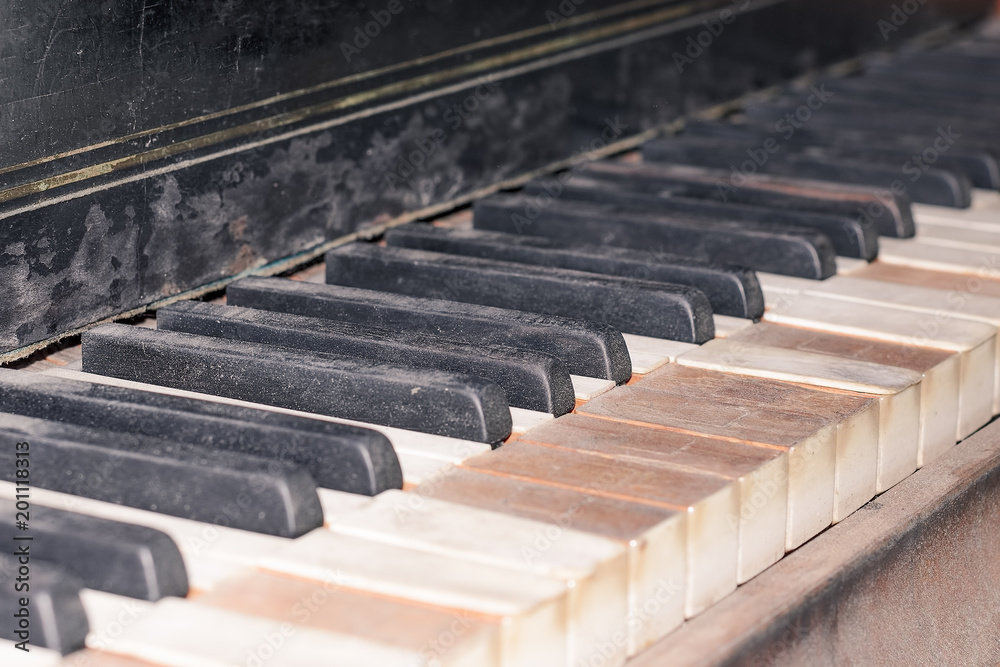 Keys of an old classical grand piano closeup