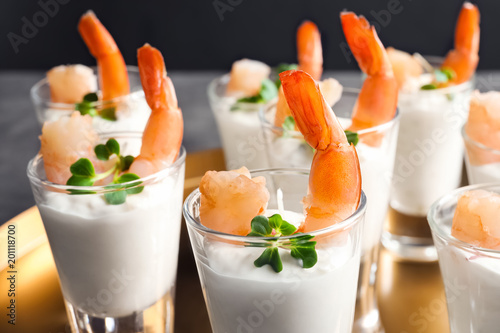 Glasses with boiled shrimps and sauce on tray