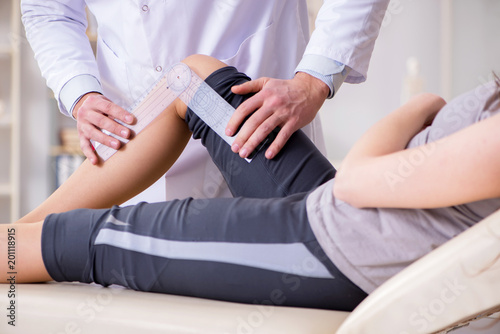 Doctor checking patients joint flexibility