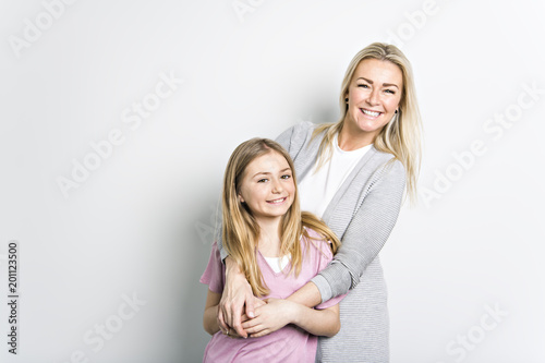 Portrait of two people, young mother and daughter, studio image