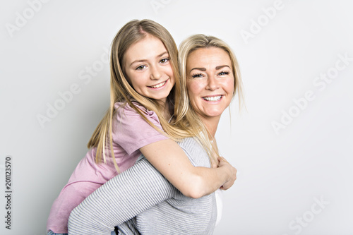 Portrait of two people, young mother and daughter, studio image