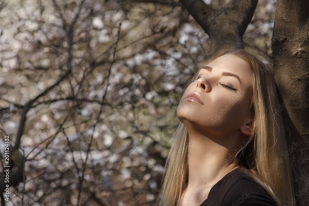 A girl in the park enjoying warm sunlight. A girl in the park enjoying warm sunlight.