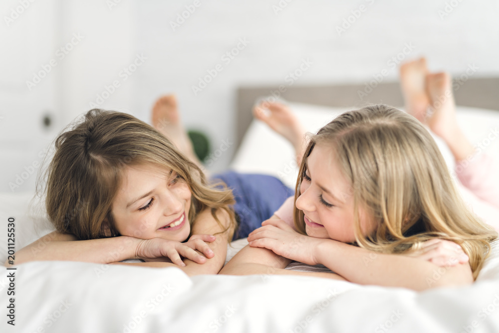 Portrait of two girls child friend in bed wearing pajamas Portrait of two girls child friend in bed wearing pajamas