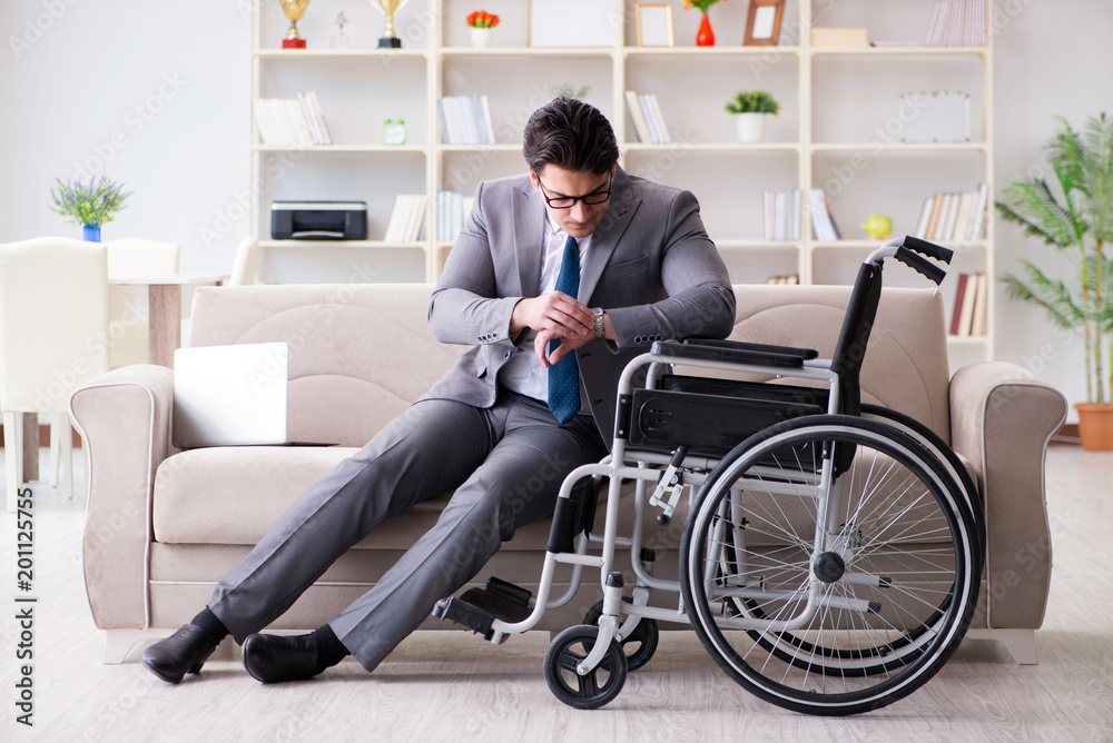Dsabled businessman on wheelchair working home
