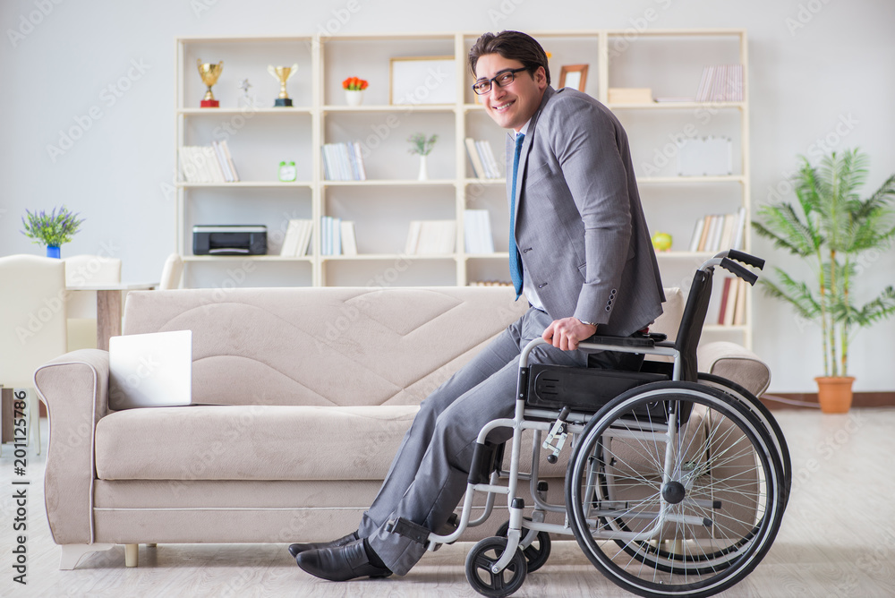 Dsabled businessman on wheelchair working home Dsabled businessman on wheelchair working home