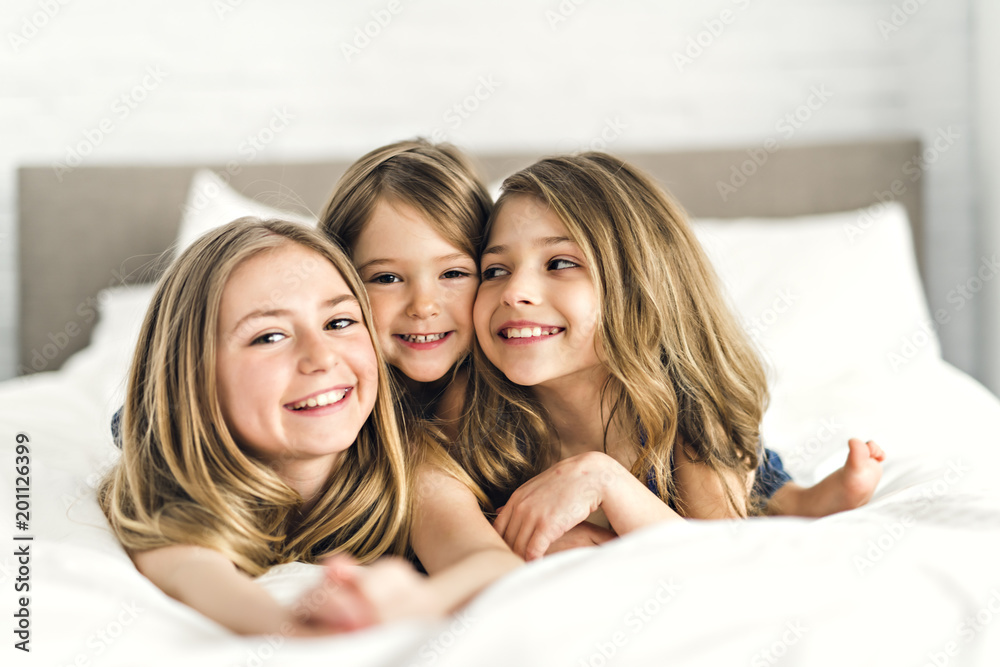 Portrait of three girls child friend in bed wearing pajamas Portrait of three girls child friend in bed wearing pajamas