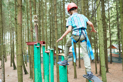 boy at climbing activity in high wire forest park