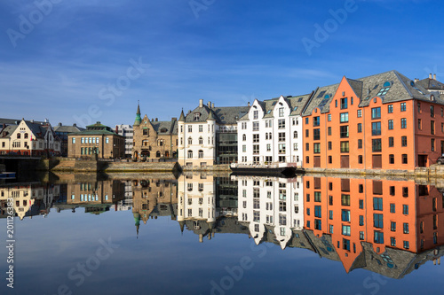 Architecture of Alesund town reflected in the marina canal, Norway