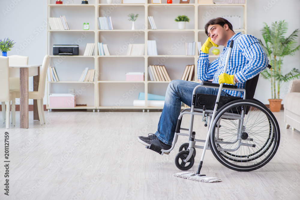 Disabled man on wheelchair cleaning home Disabled man on wheelchair cleaning home