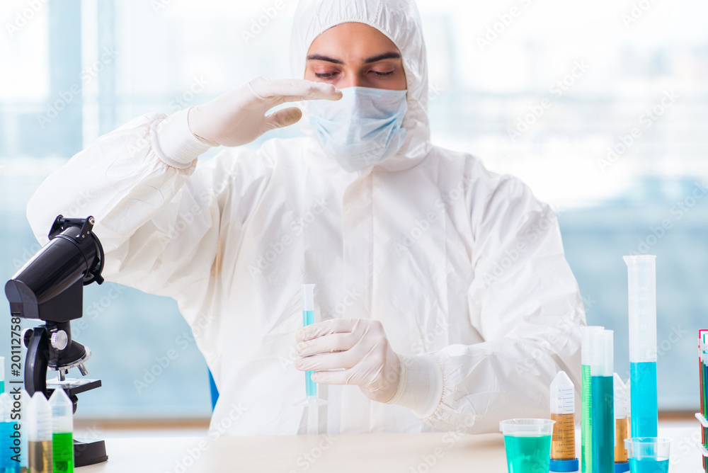 Young chemist student working in lab on chemicals Young chemist student working in lab on chemicals