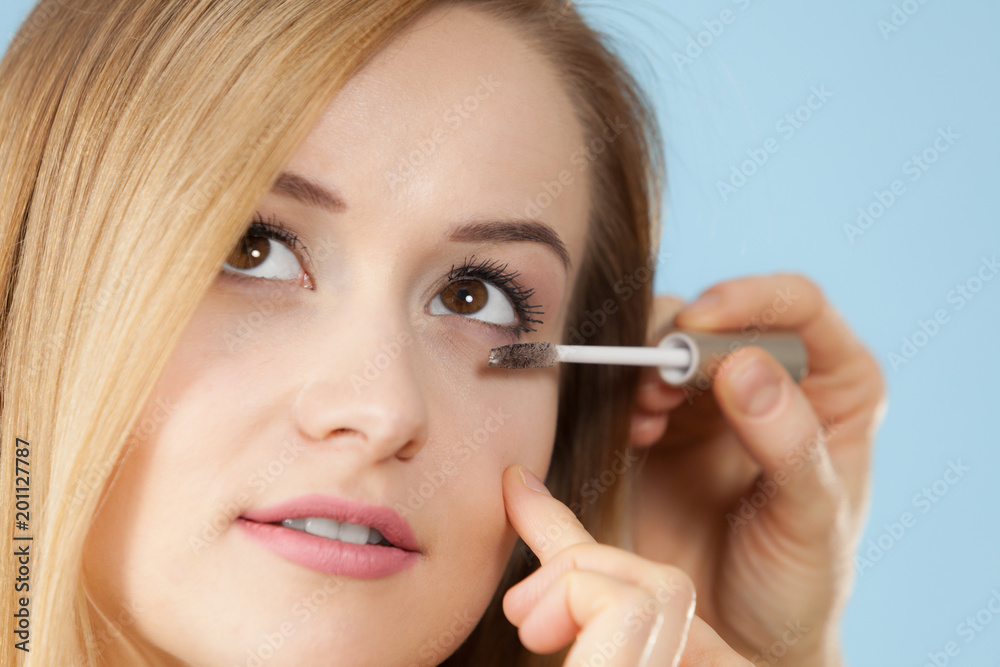 Woman getting make up done by artist