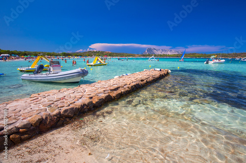 Fototapeta Naklejka Na Ścianę i Meble -  Cala Brandinchi beach with Isola Travolara in the background, red stones and azure clear water, Sardinia, Italy.