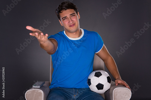 Man watching sports on gray background