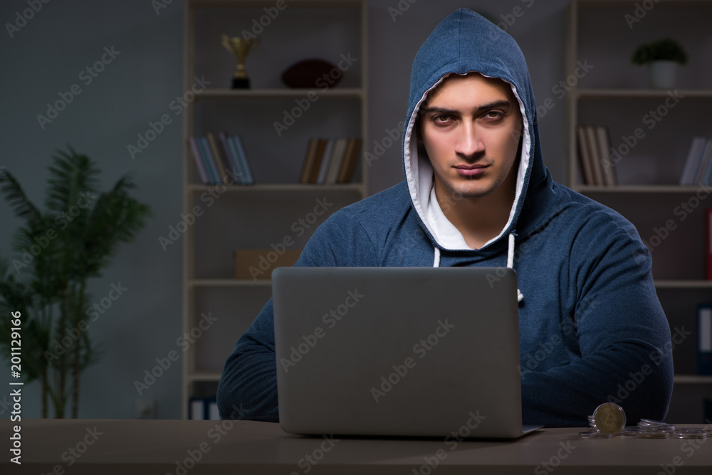 Hacker hacking the data late at night Hacker hacking the data late at night