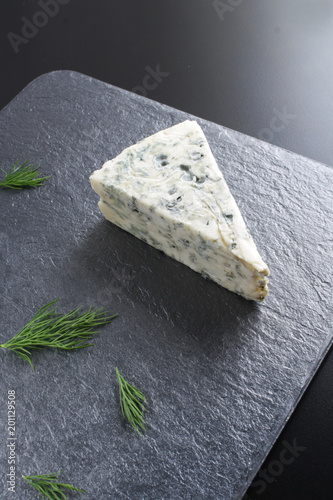 blue cheeseon a dark stone background