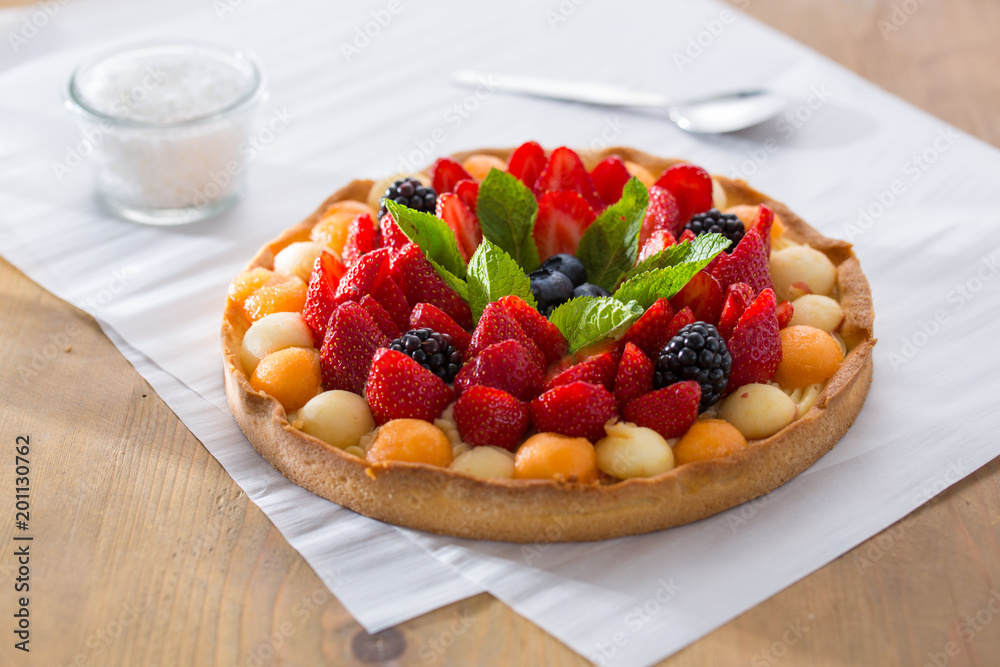 Fruit tartlet on baking pape Fruit tartlet on baking pape
