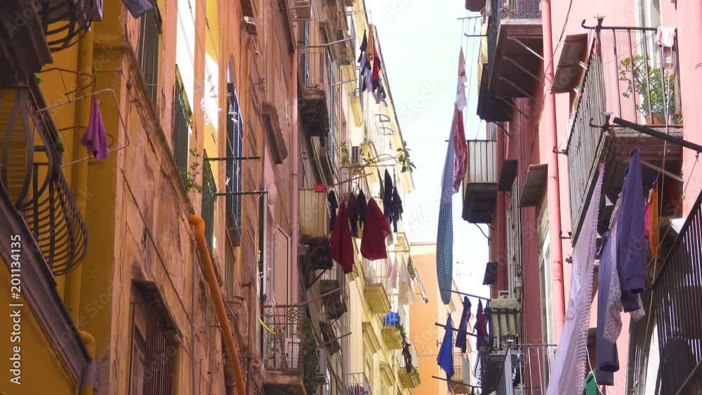 Colored clothes drying on the balcony of an old house in Italian city Colored clothes drying on the balcony of an old house in Italian city
