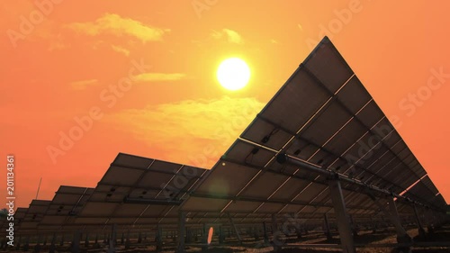 Solar power panels tracking sunrise with  morning warm sky time lapse