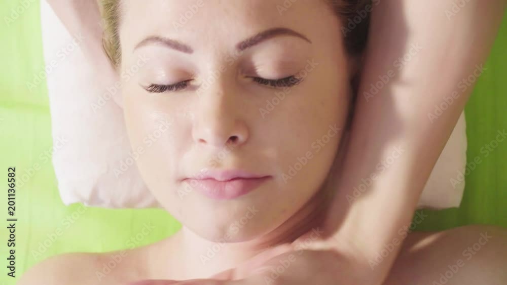 Top view. Close up hands of professional massage therapist doing chinese massage of a neck in spa salon Top view. Close up hands of professional massage therapist doing chinese massage of a neck in spa salon