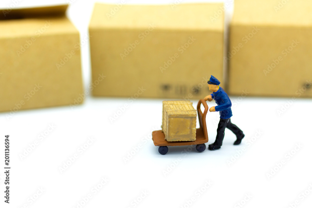 Miniature people : Worker with lifting tools with box in warehouse. Image use for industrial and logistic concept. Miniature people : Worker with lifting tools with box in warehouse. Image use for industrial and logistic concept.